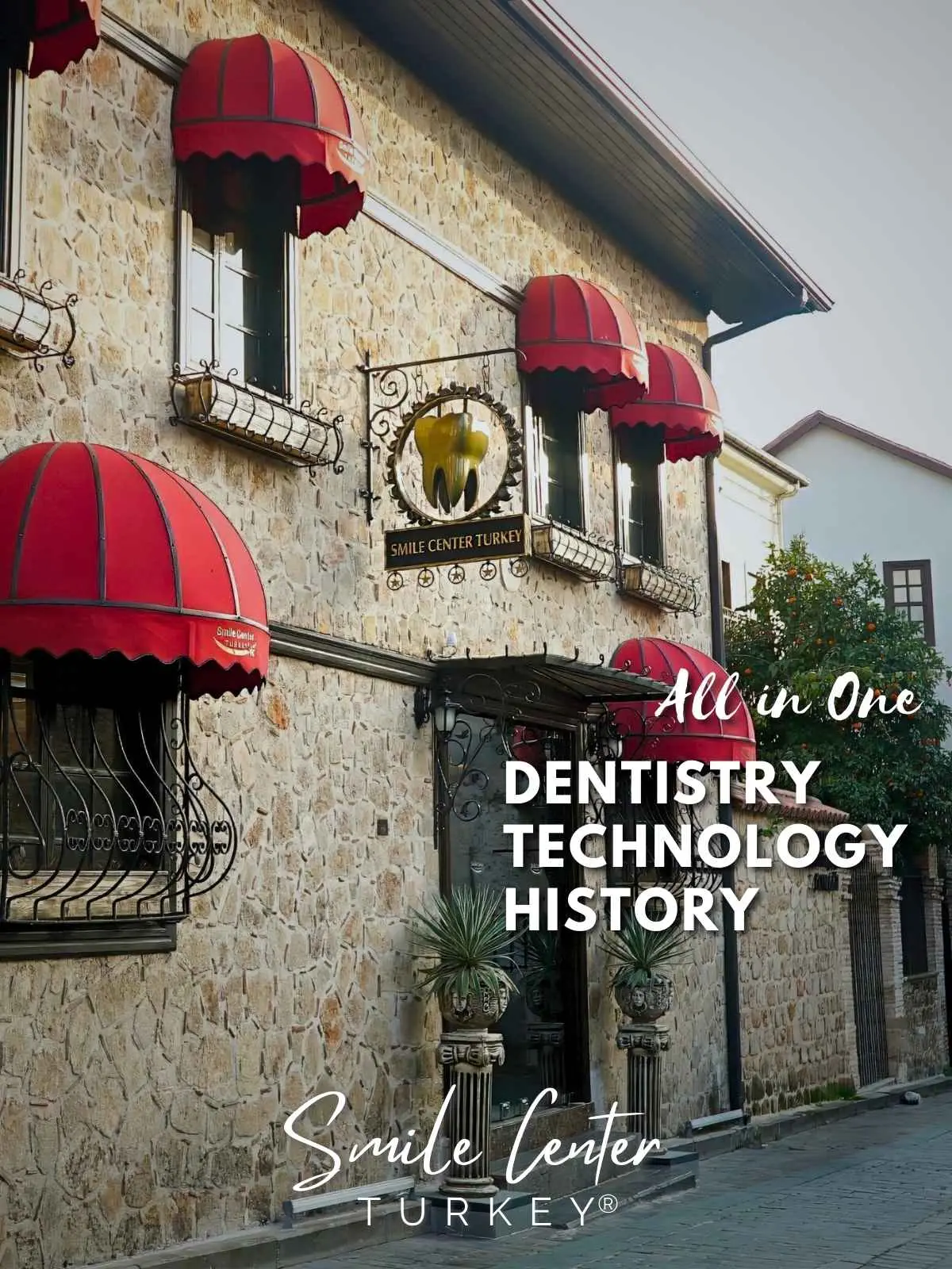 Restored stone facade of Smile Center Turkey® with red awnings and the clinic sign in Antalya's old town